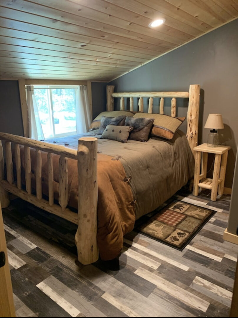 A bed room with a wooden bed and a night stand